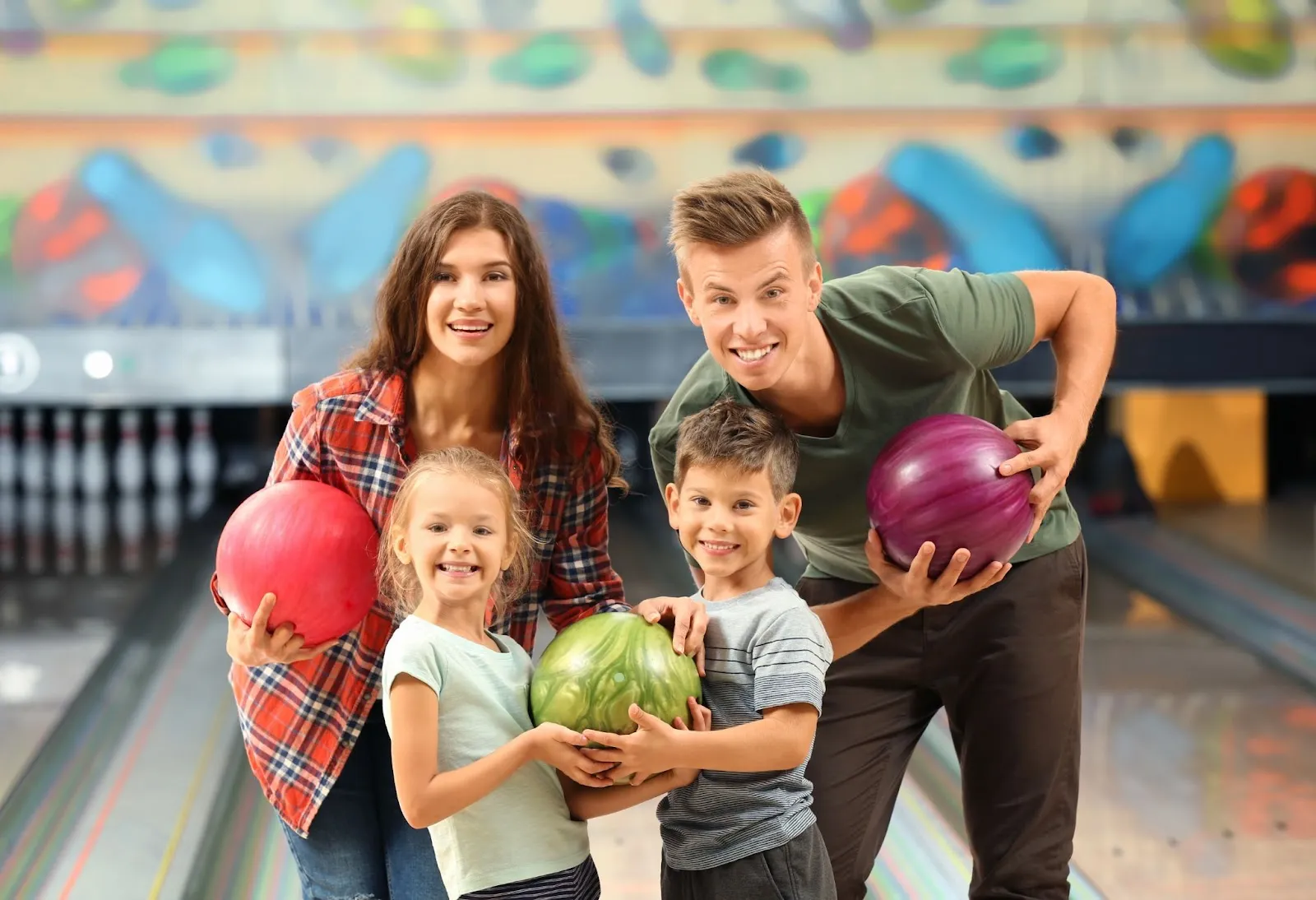 A joyful family enjoying a bowling outing together at a vibrant bowling alley, creating lasting memories.