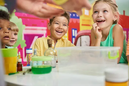 Children joyfully playing with various toys in a bright and engaging classroom environment.
