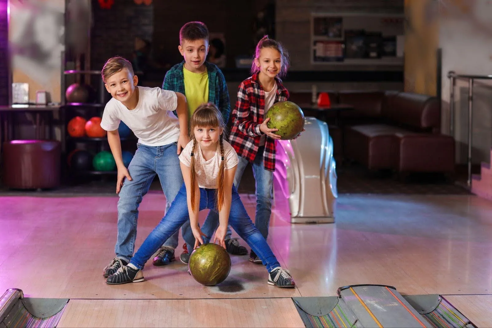 Kids bowling in a vibrant alley, showcasing teamwork